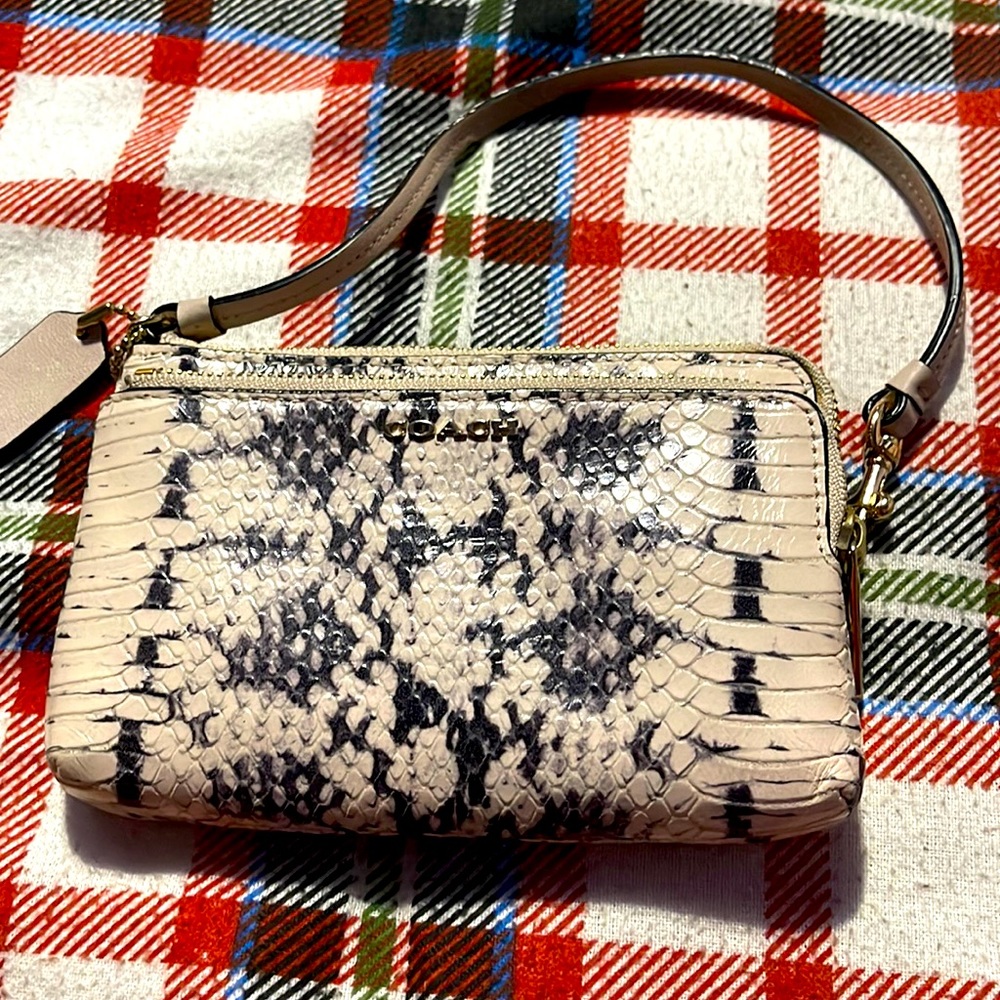 Used a few times Coach double zip mini wristlet in pink/black snake skin